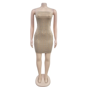 Detail of nude bodycon mini dress featuring densely arranged silver rhinestone embellishments