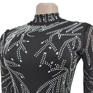 Detail view of black high neck jumpsuit with silver rhinestones and mesh sleeves