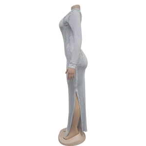 Detail showing the white long sleeve dress with side slit and sparkling silver grid sequins