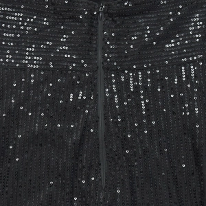 Detail of black sequin fabric with vertical patterns and smooth invisible zipper