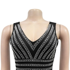Detail of black V-neck dress featuring silver rhinestones in a geometric V-shape pattern
