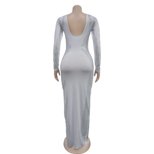 Detail of white long sleeve evening dress featuring backless U-shape and silver rhinestone trim