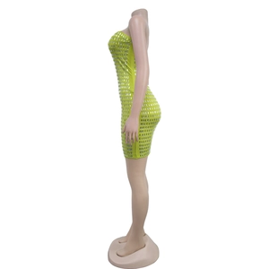 Detail of a lime green bodycon dress featuring silver rectangular rhinestone embellishments