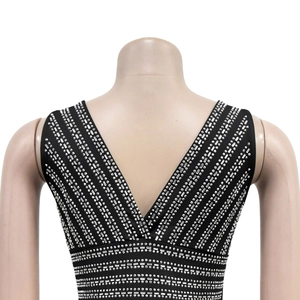 Close-up of sparkling silver rhinestones on the back of a black V-neck dress