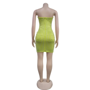 Detail view of the back of a neon green sequined bodycon party dress with hidden zipper