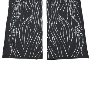 Detail of black rhinestone jumpsuit with flowing wave pattern on high-quality fabric