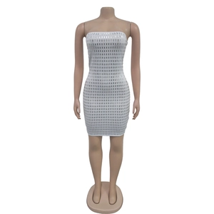 Detail of white bodycon mini dress featuring vertical silver sequin stripes and rhinestones