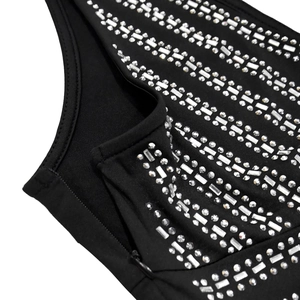 Detail of black dress featuring diagonal silver studs and sparkling rhinestone embellishments