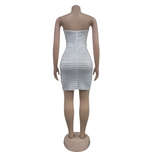 Close-up back view of white sequined bodycon mini dress featuring an invisible zipper