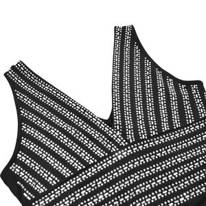 Detailed close-up of rhinestone patterns on a black sleeveless V-neck evening dress