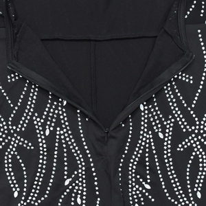 Close-up of black backless jumpsuit with silver rhinestones and invisible zipper detail