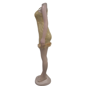 Detailed view of the gold sequin fabric texture and luxury feather trim on the mini dress