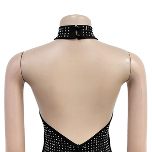 Close-up of sparkling silver rhinestones on a black halter neck dress with back buttons