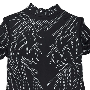 Close-up of black high-neck jumpsuit with shimmering rhinestone curves and mesh cuffs