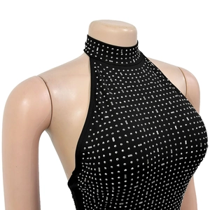 Detail of a black halter sleeveless dress with dense silver rhinestones and open back