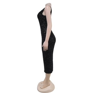 Detail view of shimmering black sequins and fabric texture on a slim fit midi dress