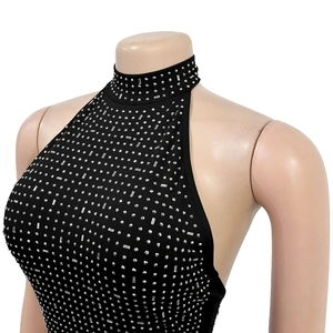 Detailed close-up of a black bodycon dress featuring silver rhinestone matrix and halter neck