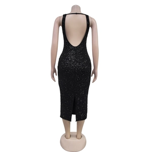 Macro detail of black sequin dress featuring a deep U-back design and a stylish rear hem slit