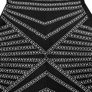 Close-up of sparkling silver rhinestones in geometric pattern on black sleeveless dress