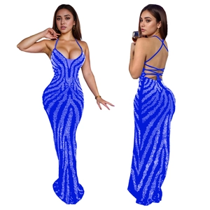 Detail of royal blue backless dress featuring silver sequins and cross strap design