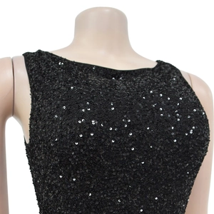 Macro view of black sequined evening dress fabric with shimmering round sequins details