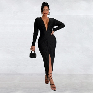 Detail of the high slit and ruched waist on a slim-fit black deep V-neck dress