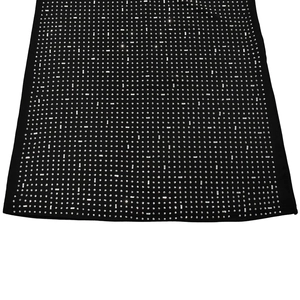 Detail of silver baguette and round rhinestones on black bodycon dress fabric