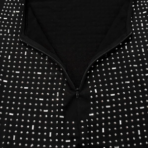 Close-up of the back hidden zipper and sparkling rhinestone patterns on a black dress