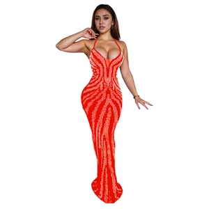 Detail of red halter neck evening gown with white wavy rhinestone patterns on a slim silhouette