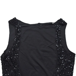 Detailed macro view of black sequined embroidery and adjustable back strap on the dress