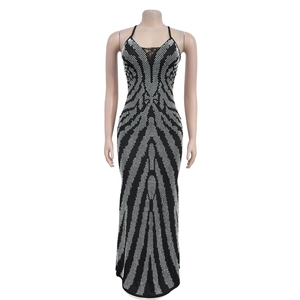 Detail of black maxi dress featuring silver rhinestone geometric pattern and spaghetti straps