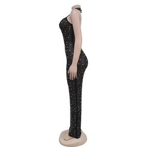 Detail of a slim-fit black halter neck dress with sparkling rhinestone embellishments