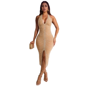Detail of beige halter dress featuring intricate rhinestone wave patterns and high slit