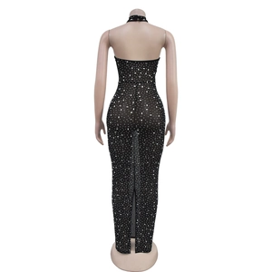 Detail view of black halter backless dress featuring sparkling rhinestones and a high slit