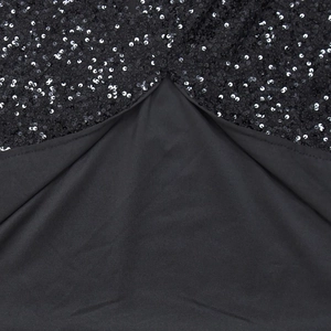 Close-up of black sequin stitching and fabric texture on backless fashion dress