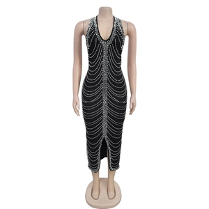 Detail of black halter neck dress with sparkling rhinestone fringe pattern and midi length