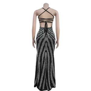 Detailed back view of a black backless dress with white rhinestone patterns and crisscross straps