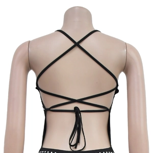 Détail d'une robe noire sexy dos nu avec bretelles croisées et ourlet à pois blancs