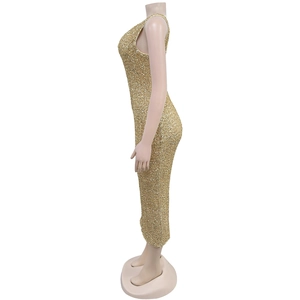 Detailed side view of a shimmering gold sequin halter gown with a sleek floor-length fit