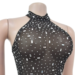 Detail of black mesh halter top featuring sparkling white rhinestones and sheer fabric texture