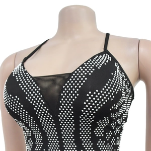 Close-up of black rhinestone backless dress featuring mesh insert and silver studs