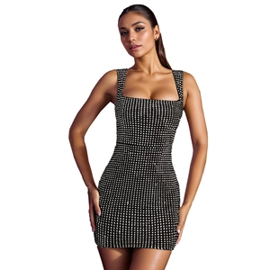Detail of a black mini dress featuring white rhinestone square patterns and thick straps