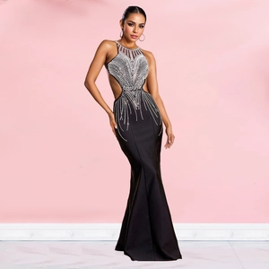 Detail of black fishtail dress with silver rhinestones, sheer mesh and waist cutouts