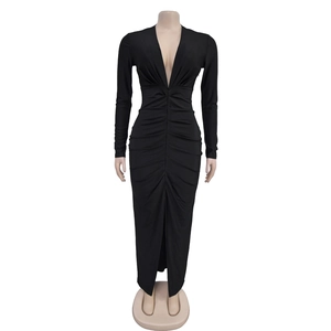 Detail of elegant black long sleeve V-neck dress with ruched body and high side slit