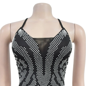 Close-up of black V-neck dress with sparkling rhinestones and mesh patchwork detail