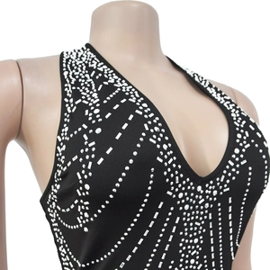 Detail of black V-neck halter dress featuring intricate silver rhinestone patterns