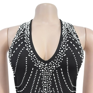 Detailed view of deep V-neck black dress with sparkling rhinestone geometric patterns