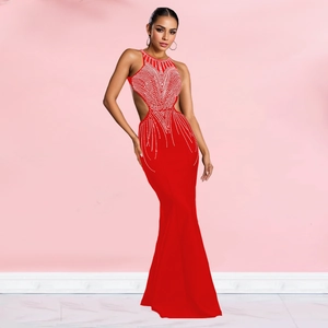 Detail of red halter fishtail evening dress with waist cut-outs and rhinestone patterns
