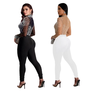 Detail of sheer mesh jumpsuit with rhinestones, showing back view in black and white colors