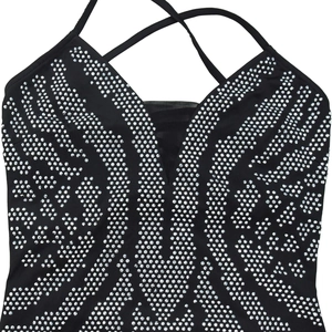 Detail of deep V-neck black dress featuring silver rhinestones and mesh patchwork